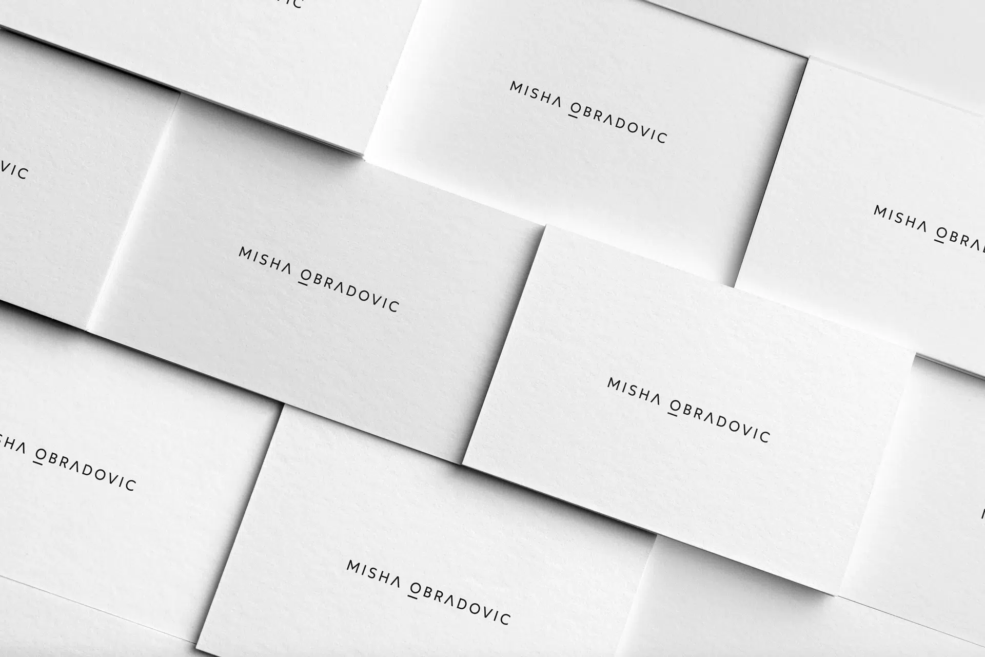 Misha Obradovic brand identity with monochrome tones, sharp typography, and editorial layouts that showcase fashion and cultural photography with intimacy.