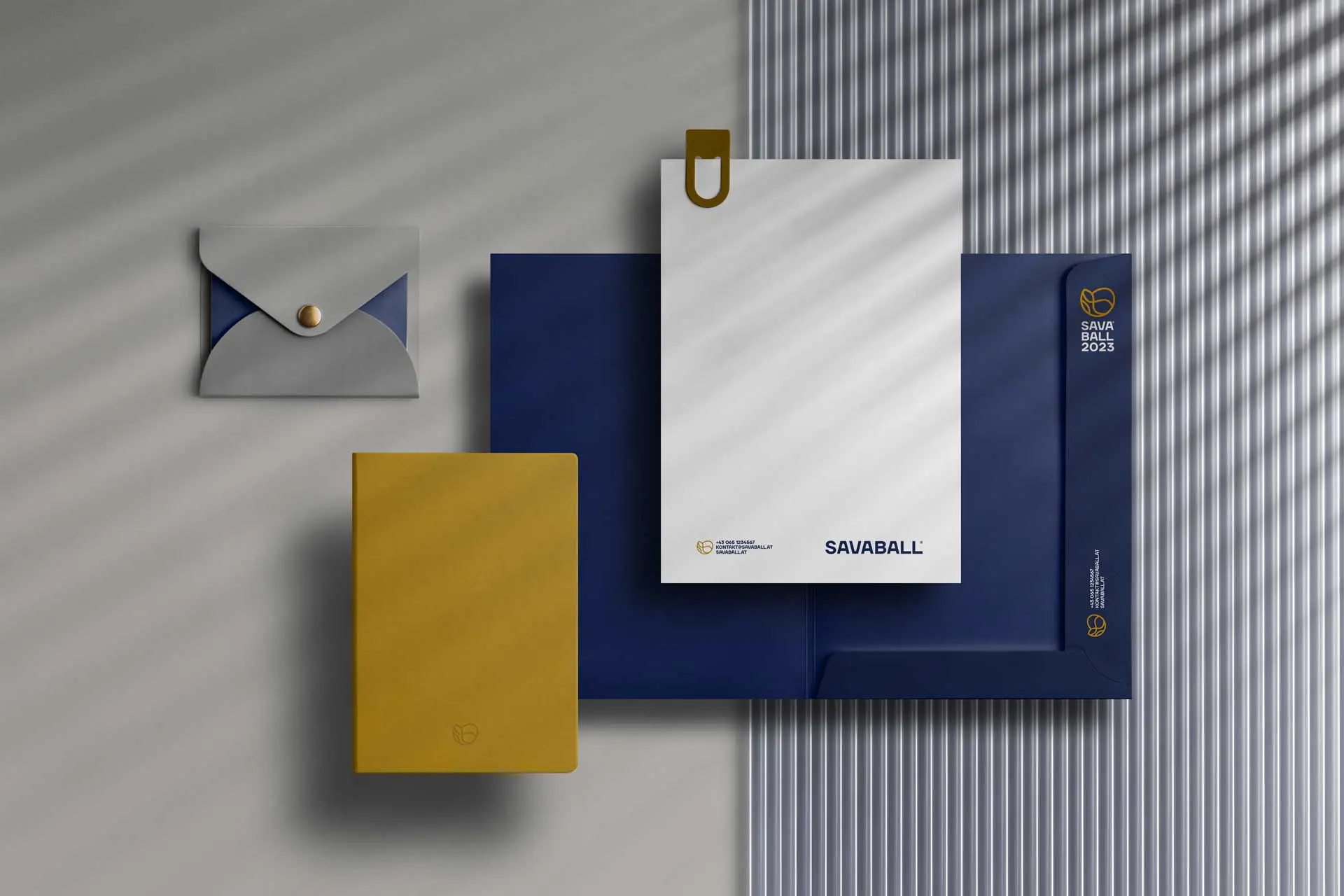 Visual identity for Savaball, featuring a swirling logo, elegant typography, and a rich palette of deep blue and yellow, reflecting Balkan culture in a Viennese ballroom setting.
